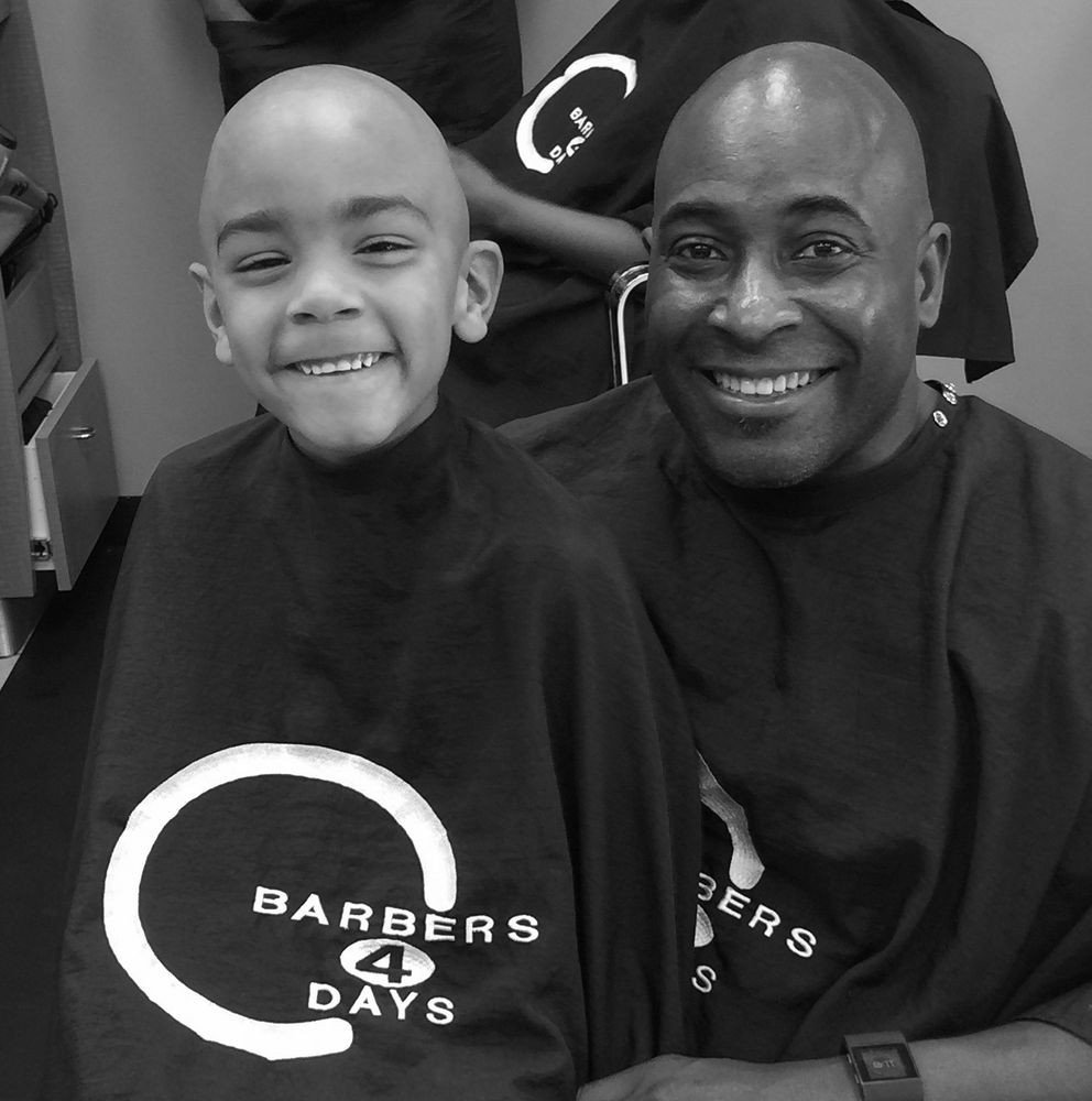Father and son with fresh cuts at Barbers 4 Days